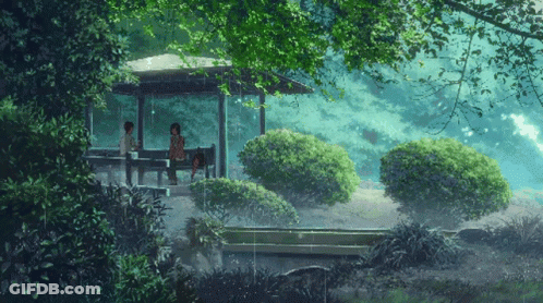 A Couple Sits Under A Gazebo In The Rain GIF