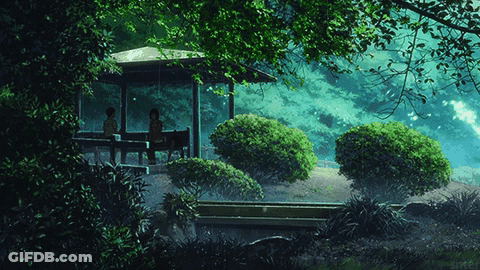 A Couple Sitting Under A Gazebo In A Forest GIF