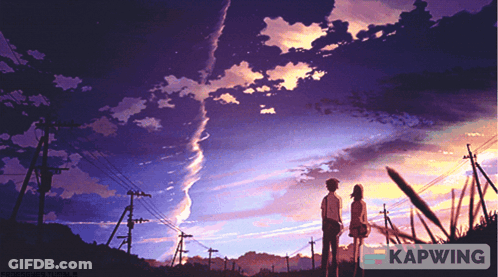 A Couple Standing In Front Of A Sunset With Kapwing In The Bottom Right Corner GIF