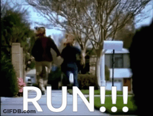 A Couple Walking Down A Street With The Word Run In White GIF