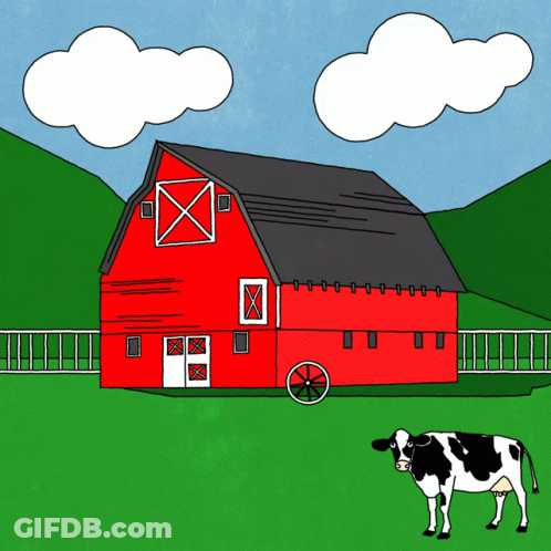 A Cow Stands In Front Of A Red Barn On A Farm GIF