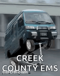 A Creek County Ems Poster With A Blue Van On A Scooter GIF