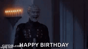 A Creepy Man Is Screaming And Saying `` Happy Birthday '' In A Room With Candles . GIF