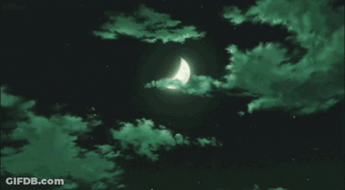 A Crescent Moon In A Dark Night Sky With Green Clouds . GIF