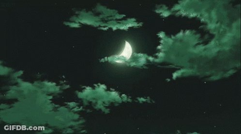 A Crescent Moon Is Surrounded By Green Clouds In A Dark Sky GIF