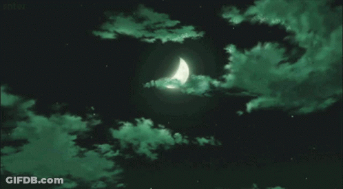 A Crescent Moon Is Visible In A Dark Sky With Green Clouds GIF