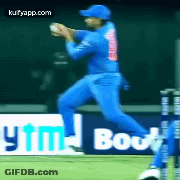 A Cricket Player In A Blue Uniform Is Playing A Game Of Cricket . GIF