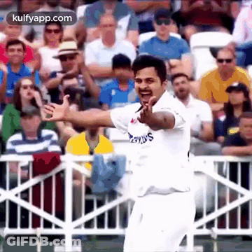 A Cricket Player Is Giving A Thumbs Up In Front Of A Crowd . GIF