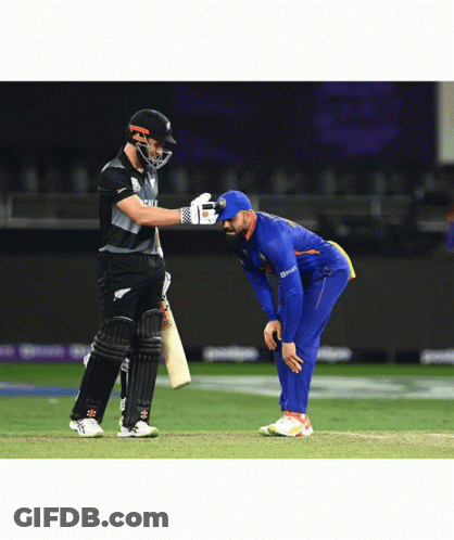 A Cricket Player Wearing A Blue Jersey That Says ' Deccan ' On It Talks To Another Player GIF