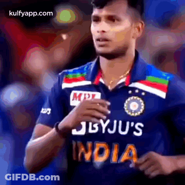A Cricket Player Wearing A Blue Jersey With The Word India On It . GIF