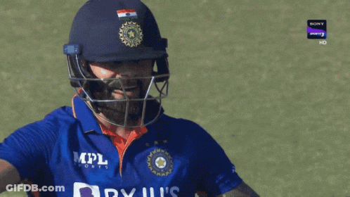 A Cricket Player Wearing A Helmet And A Blue Shirt That Says Byju 'S India GIF