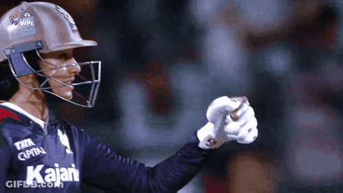 A Cricket Player Wearing A Helmet And A Jersey That Says Kajian GIF