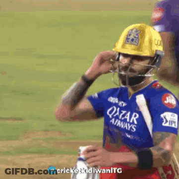 A Cricket Player Wearing A Helmet And A Qatar Airways Shirt GIF