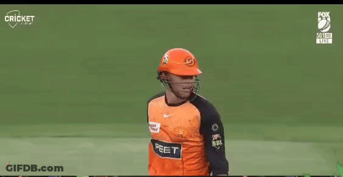 A Cricket Player Wearing A Helmet And Holding A Bat On A Field GIF