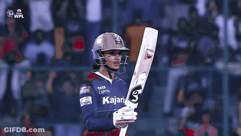 A Cricket Player Wearing A Helmet And Holding A Bat That Says Tata Capital GIF