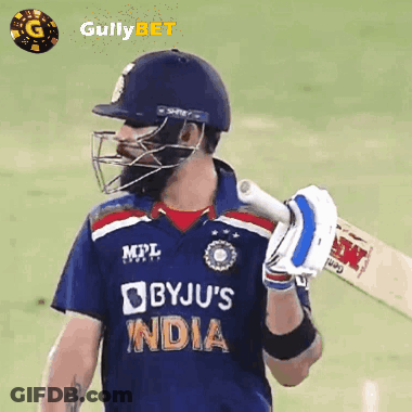 A Cricket Player Wearing A Helmet And Holding A Bat With The Word India On His Jersey GIF