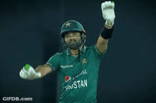 A Cricket Player Wearing A Pepsi Shirt Holds His Arms Up In The Air GIF