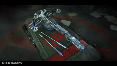 A Crossbow Is Sitting On Top Of A Box That Says " Fight The Dead " GIF