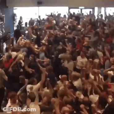 A Crowd Of People Are Dancing In A Room GIF