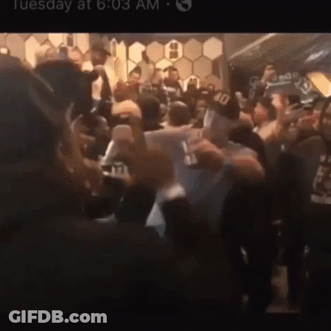 A Crowd Of People Are Gathered In A Room With The Time Of 6:03 GIF