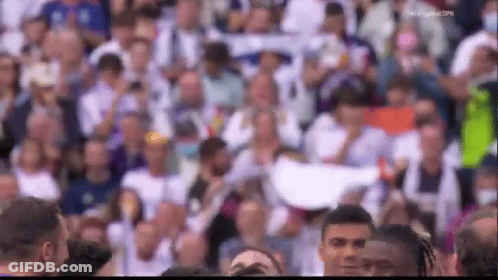 A Crowd Of People Are Gathered In A Stadium Watching A Basketball Game . GIF