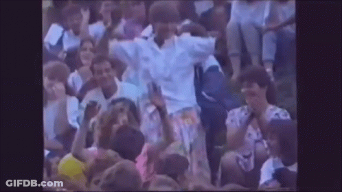 A Crowd Of People Are Gathered In A Stadium Watching A Game . GIF