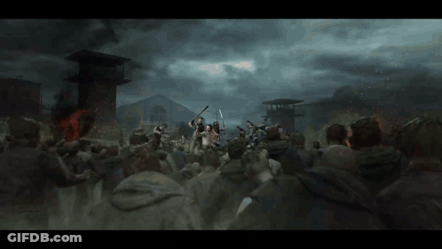 A Crowd Of People Are Gathered In Front Of A Building With A Fire In The Background GIF