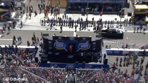 A Crowd Of People Are Gathered In Front Of A Stage That Says 500 On It GIF