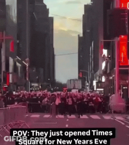 A Crowd Of People Are Gathered On A City Street With The Caption " They Just Opened Times Square For New Years Eve " GIF