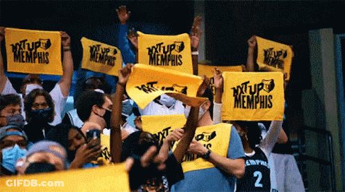 A Crowd Of People Are Holding Up Yellow Signs That Say ' Xtup Memphis ' GIF