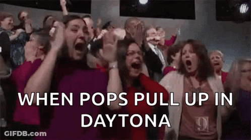 A Crowd Of People Are Screaming In A Theater While Watching A Show . GIF