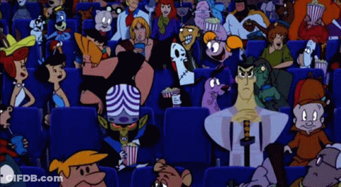 A Crowd Of People Are Sitting In A Movie Theater Watching A Movie . GIF