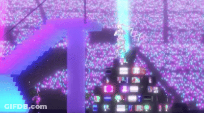 A Crowd Of People Are Watching A Concert In A Stadium Filled With Lots Of Lights . GIF