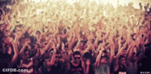 A Crowd Of People At A Concert With One Man Wearing A Shirt That Says ' O.k.f.w. ' GIF