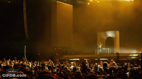 A Crowd Of People At A Concert With The Word Cancabella On The Bottom Right GIF
