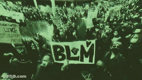 A Crowd Of People Holding Up Signs Including One That Says Blm On It GIF
