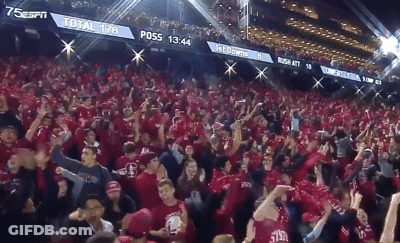 A Crowd Of People In A Stadium With A Scoreboard That Says ' Total 178 ' On It GIF