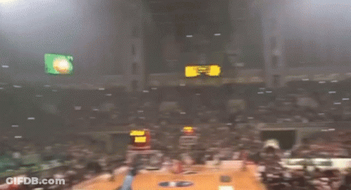A Crowd Of People In A Stadium With Smoke Coming Out Of The Stands And A Sign That Says ' A ' GIF