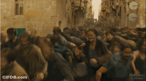 A Crowd Of People Running Down A Street With A Sign That Says Film Comics Explained On It GIF