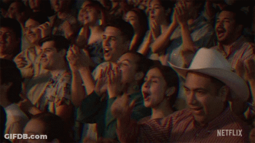 A Crowd Of People Sitting In A Stadium Applauding With Netflix Written In The Corner GIF