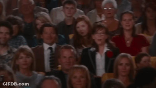 A Crowd Of People Sitting In A Stadium Watching A Presentation GIF