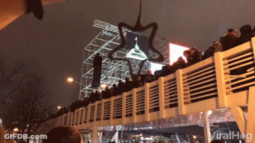 A Crowd Of People Sitting On A Bridge With The Word Viralhog Written On The Bottom GIF