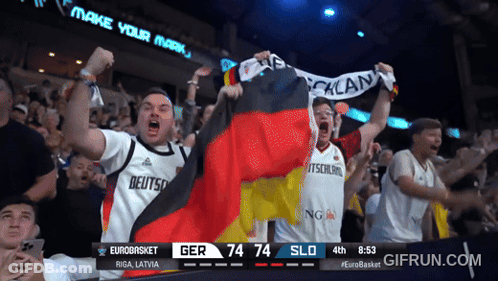 A Crowd Of People Watching A Basketball Game With A Scoreboard That Says Eurobasket Riga Latvia GIF