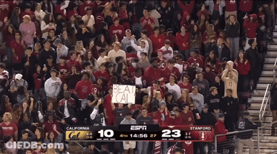 A Crowd Of People Watching A Basketball Game With A Sign That Says Beat Cal GIF