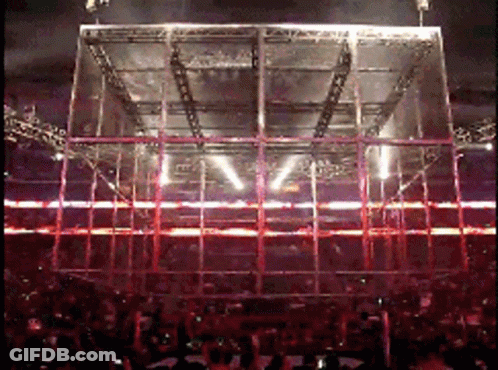 A Crowd Of People Watching A Concert With A Large Stage In The Middle GIF