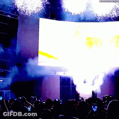 A Crowd Of People Watching A Fireworks Display With The Hashtag #Thenextbigthing GIF