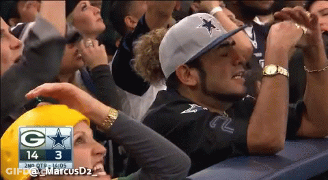 A Crowd Of People Watching A Football Game With The Score 14 3 GIF