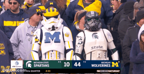 A Crowd Of People Watching A Game Between Michigan State Spartans And Wolverines GIF