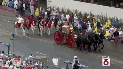 A Crowd Of People Watching A Parade With The Number 5 In The Corner GIF