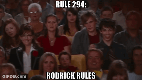 A Crowd Of People Watching A Show With Rodrick Rules Written In The Corner GIF
